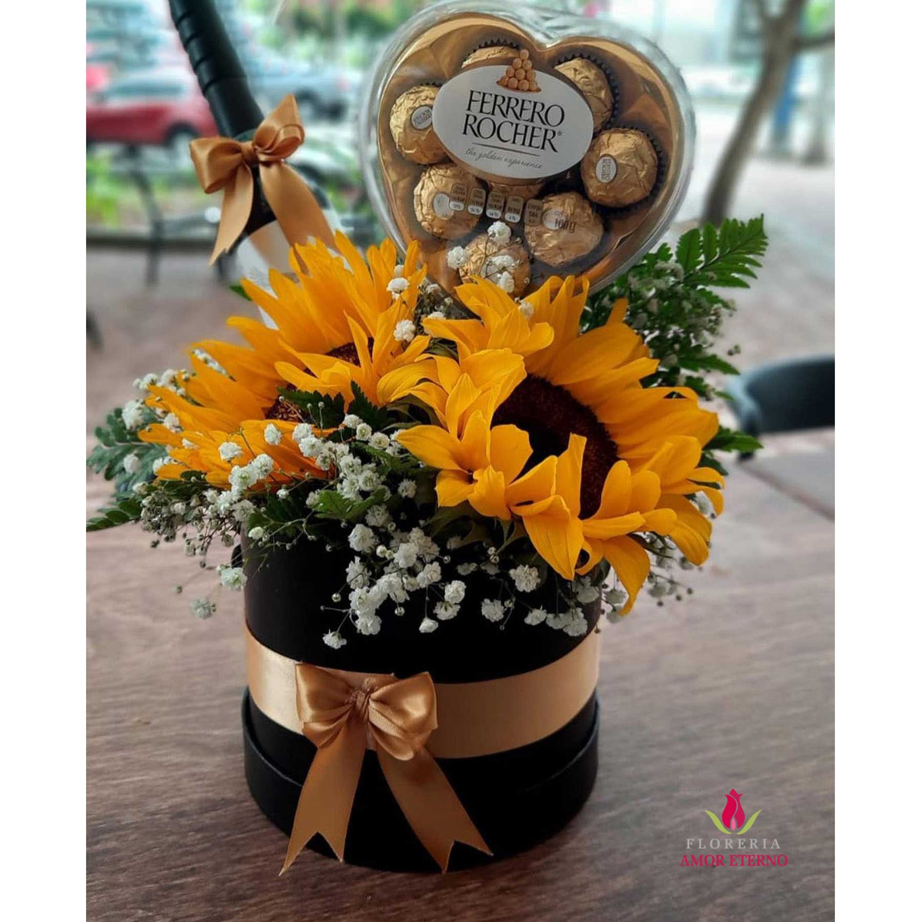 Box negro con girasol chocolate y vino.
